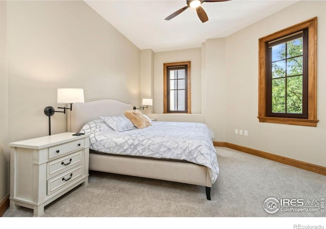 bedroom featuring light colored carpet, ceiling fan, and vaulted ceiling