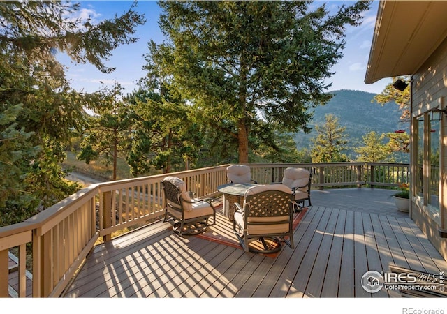 wooden deck featuring a mountain view