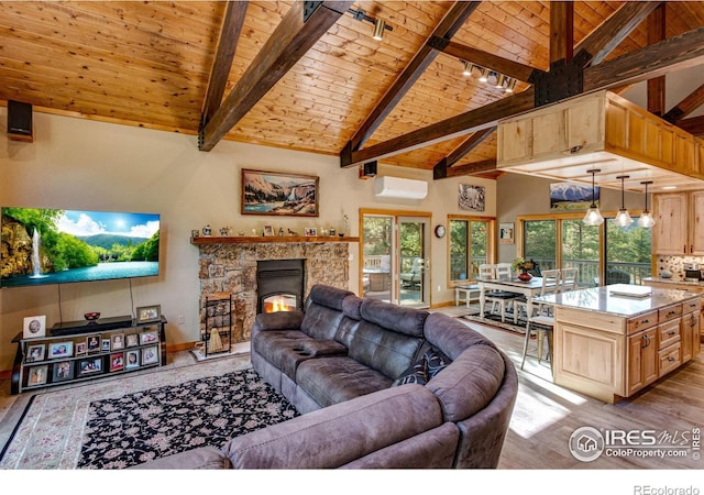 living room with a wall mounted AC, wooden ceiling, light wood-type flooring, a stone fireplace, and high vaulted ceiling