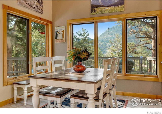 dining area with plenty of natural light and a mountain view