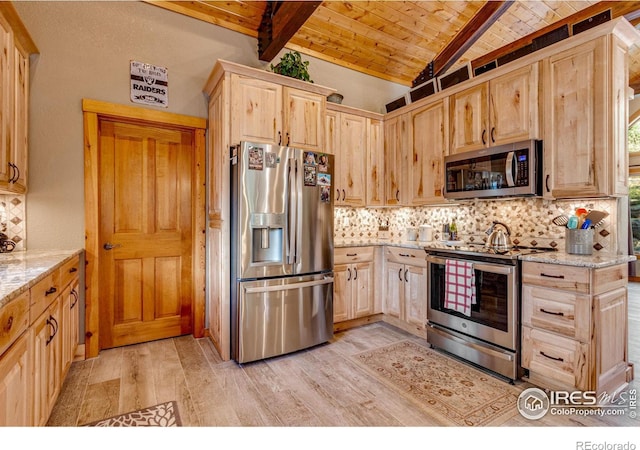 kitchen featuring light stone countertops, stainless steel appliances, light hardwood / wood-style floors, light brown cabinets, and vaulted ceiling with beams