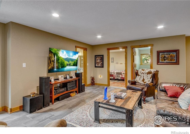 living room featuring light hardwood / wood-style floors and a textured ceiling