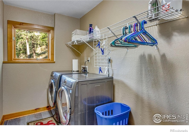 laundry room featuring washing machine and clothes dryer