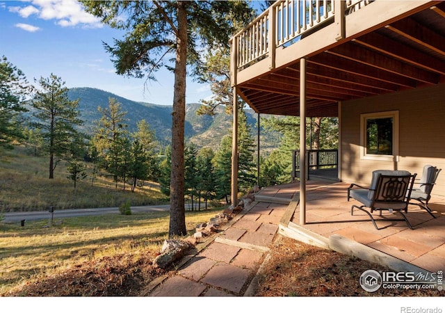 view of patio featuring a deck with mountain view