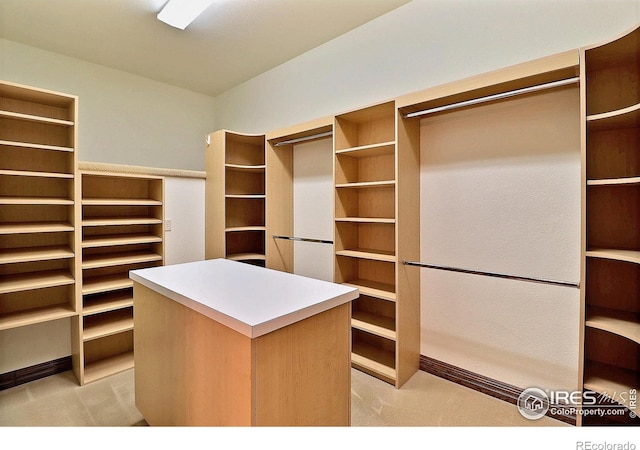 walk in closet featuring light colored carpet