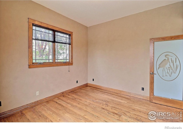 spare room featuring light wood-type flooring