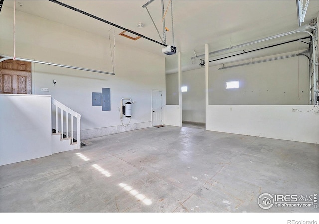 garage featuring a garage door opener and electric panel