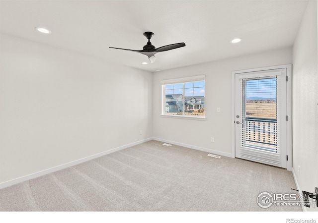 carpeted empty room featuring ceiling fan