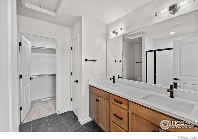 bathroom with toilet, vanity, tile patterned floors, and an enclosed shower