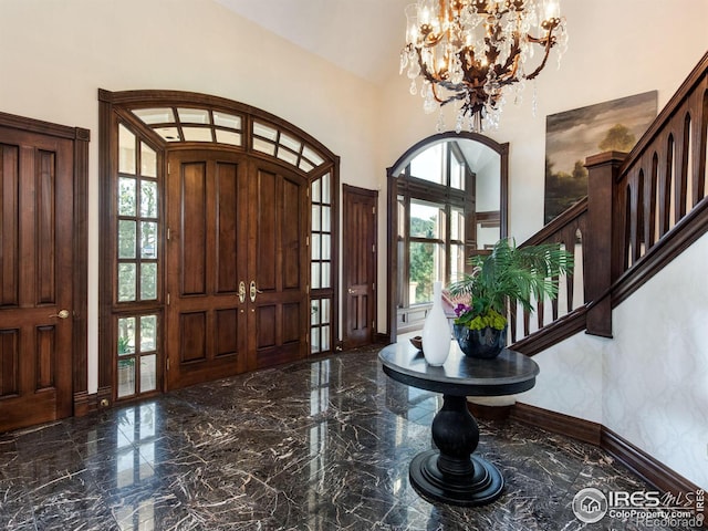 entrance foyer featuring a towering ceiling and a chandelier