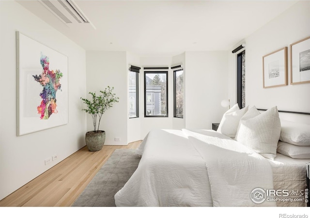 bedroom with hardwood / wood-style flooring