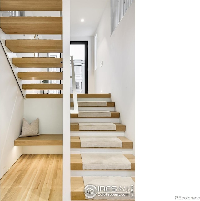 stairs featuring wood-type flooring