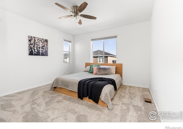 bedroom with ceiling fan and light colored carpet