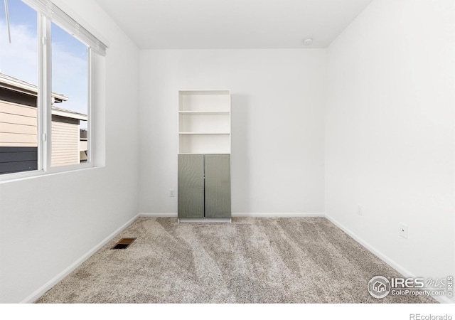 unfurnished room featuring carpet