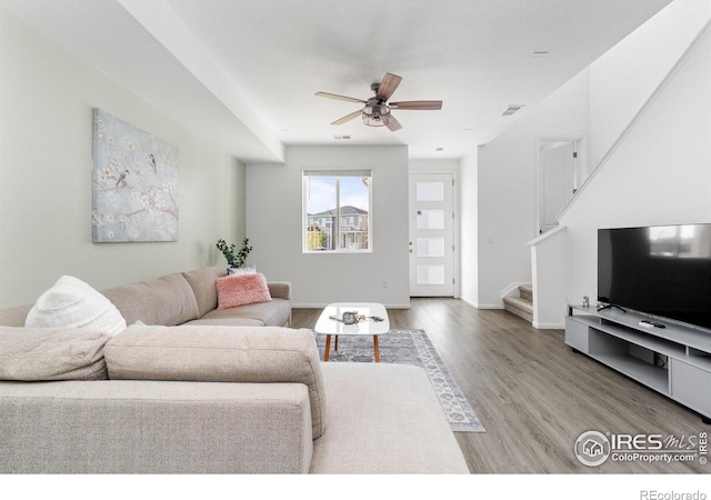 living room featuring hardwood / wood-style flooring and ceiling fan