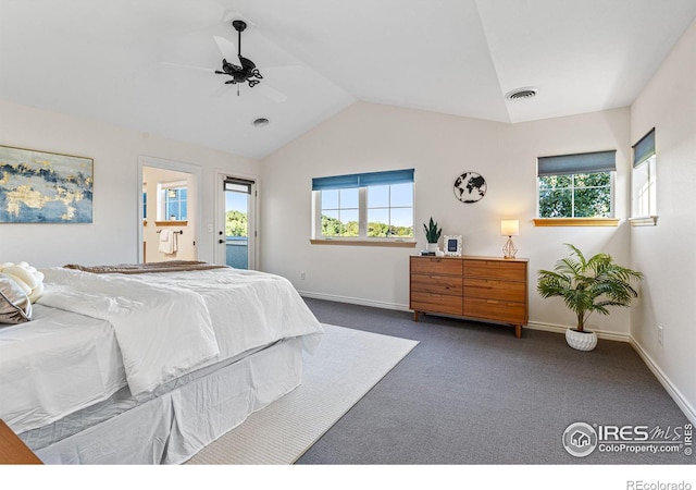 carpeted bedroom featuring lofted ceiling, ceiling fan, and ensuite bathroom