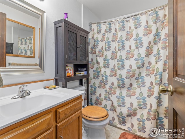 bathroom with walk in shower, vanity, toilet, and tile patterned floors