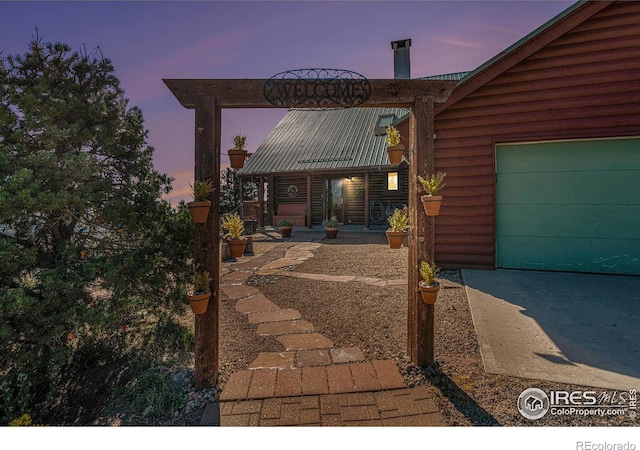 exterior space with a garage and covered porch