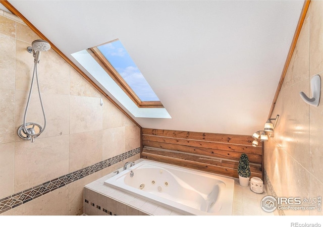 bathroom featuring plus walk in shower, lofted ceiling with skylight, and tile walls