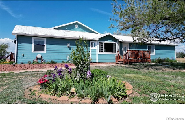 single story home with a deck and a front lawn