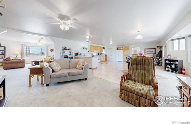 living room with ceiling fan and light tile patterned floors