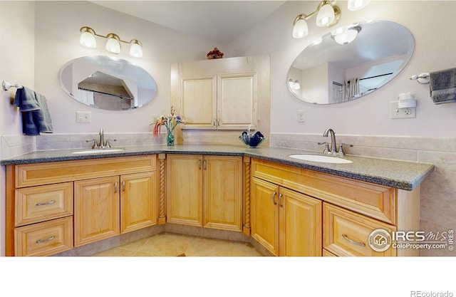 bathroom with tile patterned floors and vanity