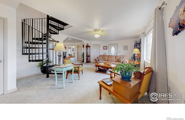 carpeted living room featuring ceiling fan