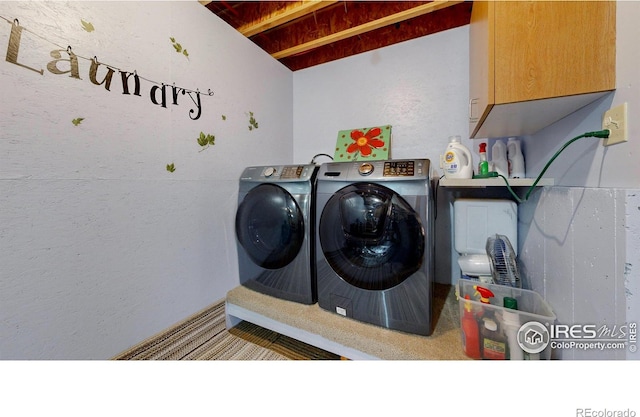 laundry room with cabinets and washing machine and dryer