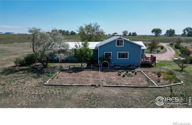 exterior space with a wooden deck and a rural view