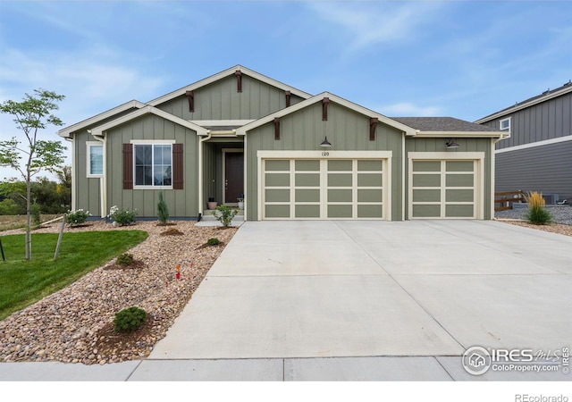 view of front of house featuring concrete driveway, an attached garage, board and batten siding, and a front lawn