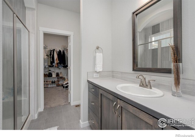 bathroom with vanity and an enclosed shower