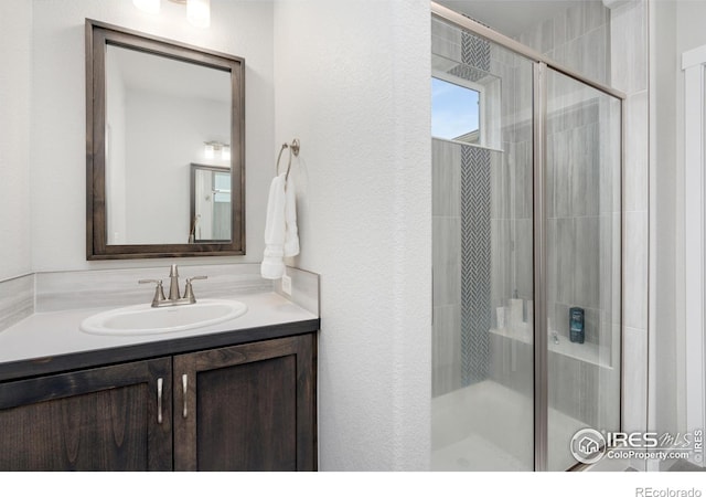 full bathroom with vanity and a shower stall