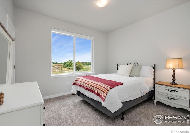 carpeted bedroom with baseboards