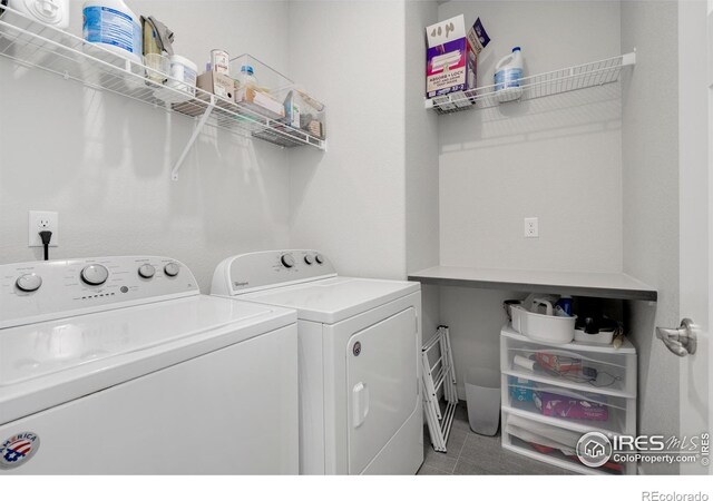 laundry area with independent washer and dryer and tile patterned floors