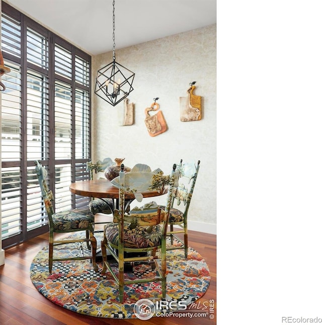 dining space featuring hardwood / wood-style flooring and a notable chandelier