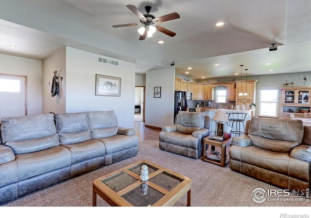 living area with ceiling fan, light colored carpet, visible vents, and recessed lighting