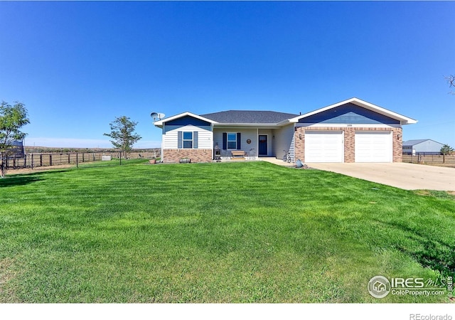 ranch-style house featuring a garage, a front yard, fence, and brick siding