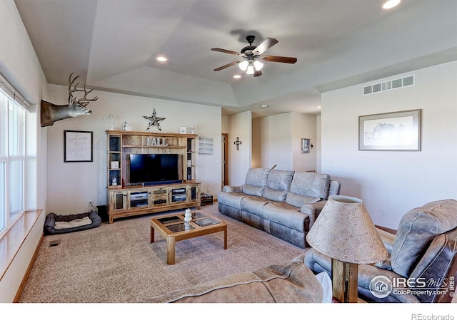 living room with visible vents, a raised ceiling, a ceiling fan, carpet flooring, and recessed lighting