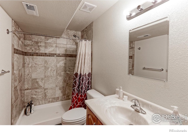 full bathroom featuring toilet, visible vents, a tile shower, and a textured wall