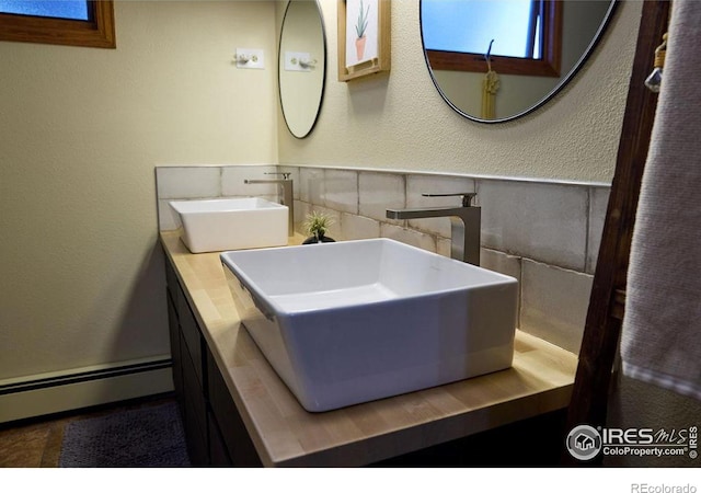 bathroom with baseboard heating and vanity