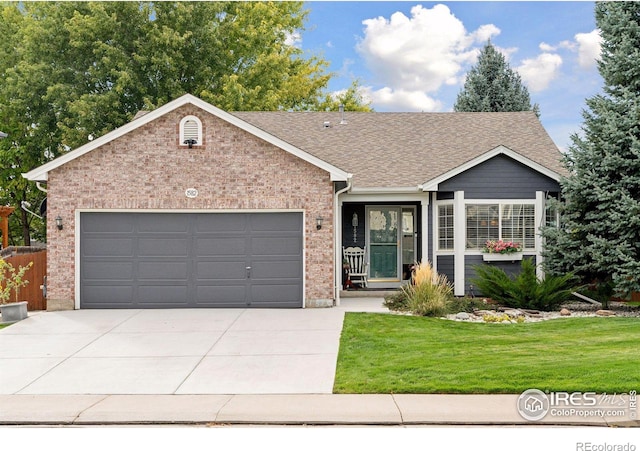 ranch-style home with a garage and a front yard