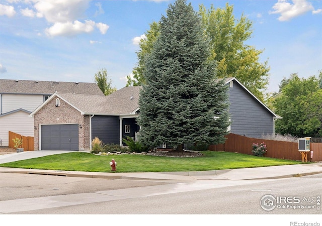 view of front of property with a front lawn and a garage