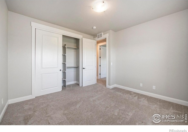 unfurnished bedroom featuring a closet and carpet