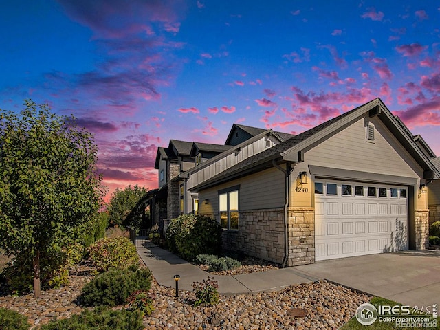 property exterior at dusk featuring a garage