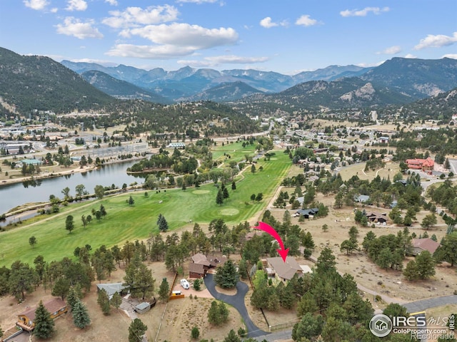 birds eye view of property with a water and mountain view