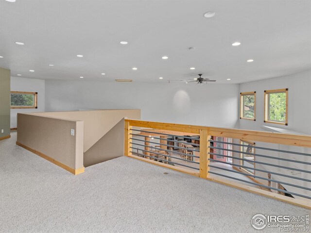 spare room featuring light carpet and ceiling fan