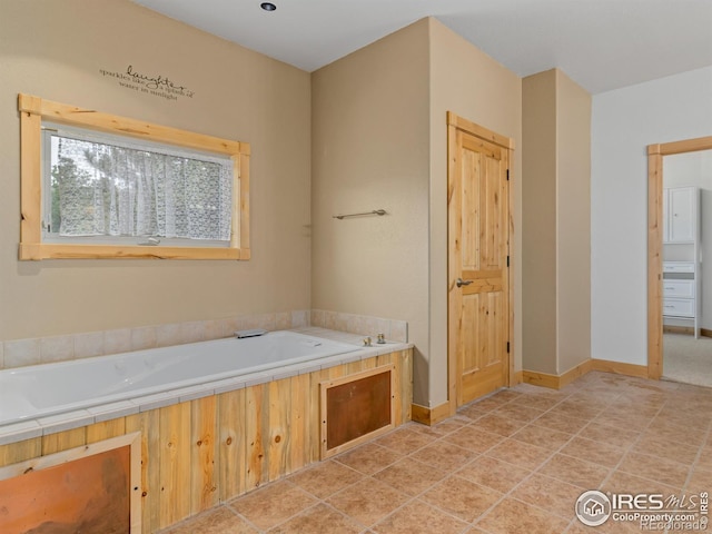 bathroom featuring tile patterned flooring and a bath