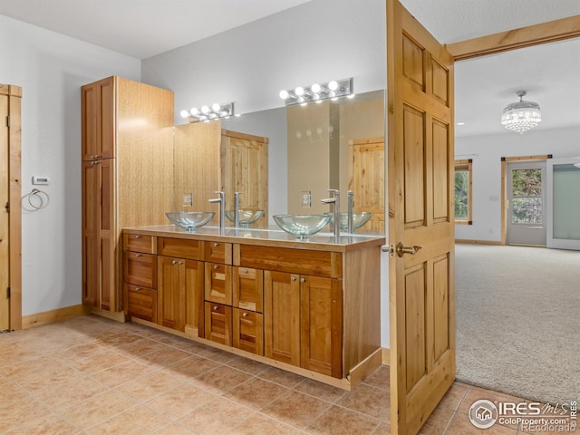 bathroom featuring tile patterned flooring, a textured ceiling, and vanity