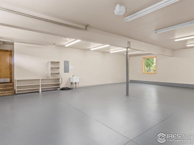 garage featuring electric panel and sink