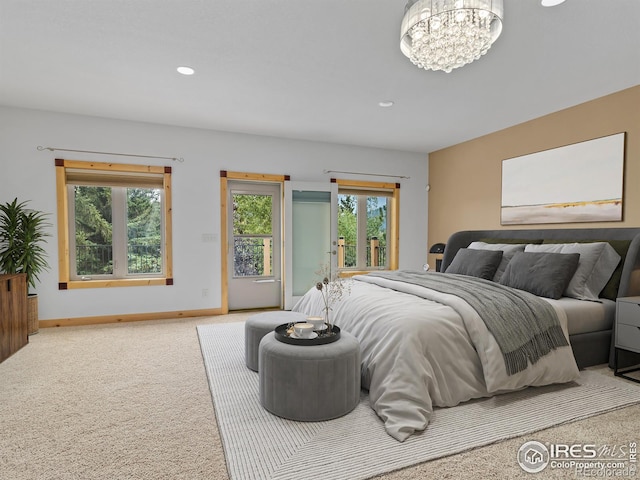 bedroom featuring access to outside, an inviting chandelier, and carpet